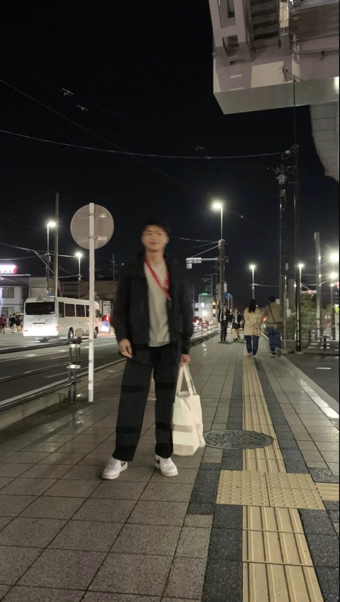 Nguyen Gia Tu standing on a lit street at night